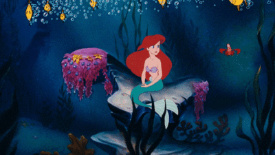 Ariel from the Little Mermaid Twirling and Swimming with Fish